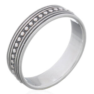 An antiqued bali beaded silver band ring