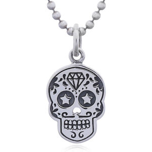 A sugar skull silver pendant star eyes
