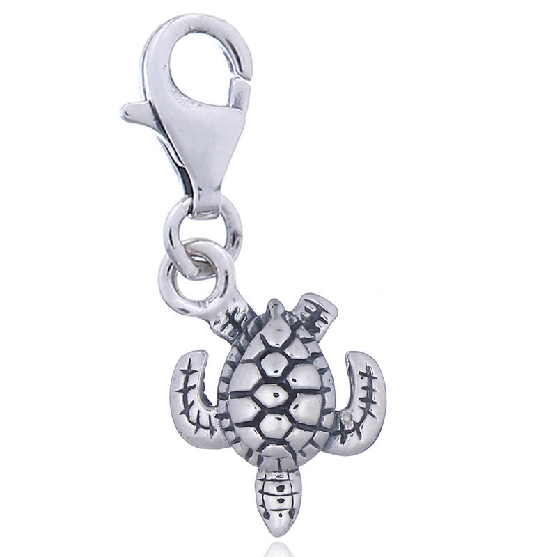 An antiqued ornate sterling silver turtle charm on lobster clasp
