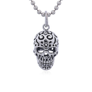 A perforated mexican sugar skull silver pendant