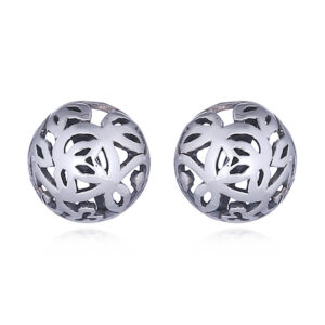 A pair of silver stud earrings round twirled leaf tendril openwork
