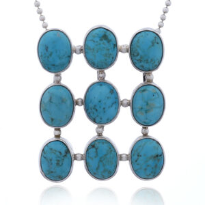 A nine oval howlite turquoise gems at silver grid pendant