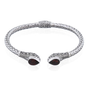 A tear drop garnet stone on bohemian hinged silver bangle