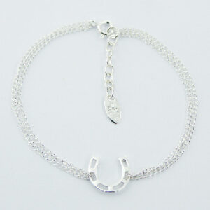 A double sterling silver curb chain bracelet with horseshoe charm