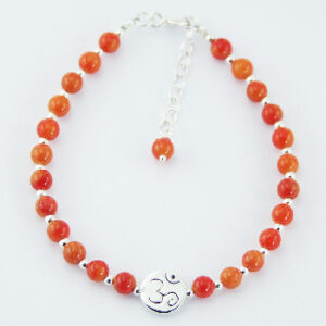 A gemstone and silver bead bracelet with polished silver om bead
