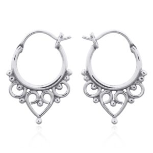 A pair of ornate tribal sterling silver hoops