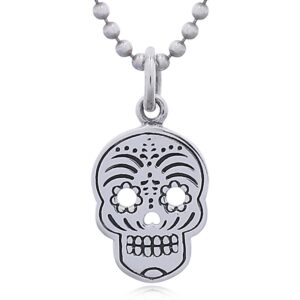 A sugar skull silver pendant perforated eyes