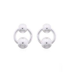 A pair of tiny circle and silver ball stud earrings