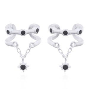 A pair of silver ear cuffs bezel set black cz and dangling star on chain